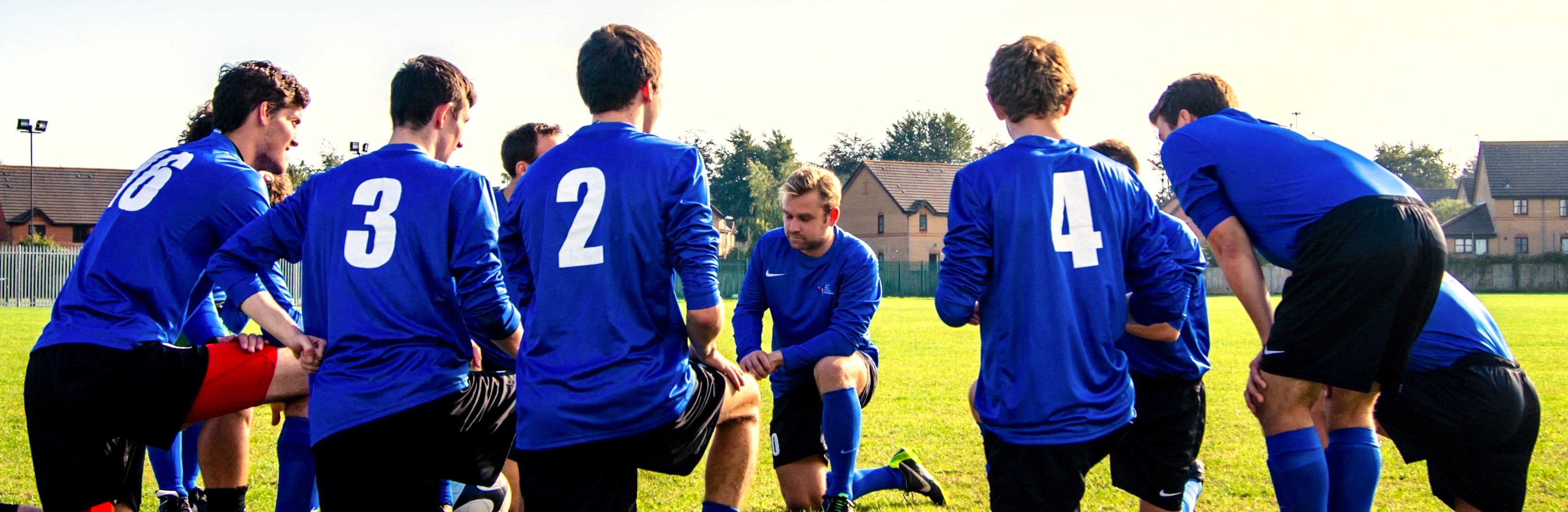 Team of Soccer players, taking a knee